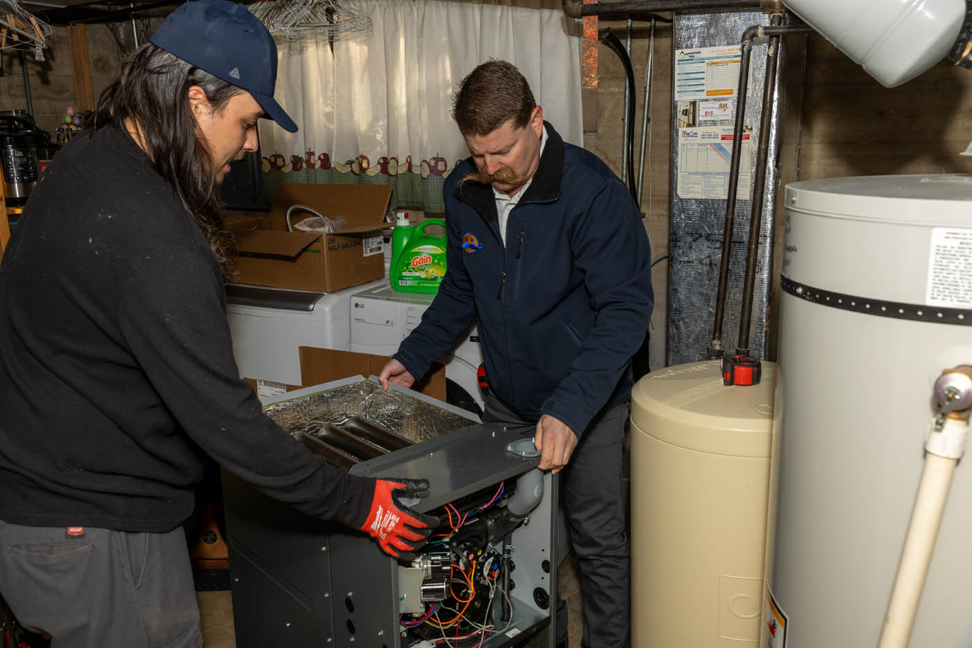 
		Two experts at Absolute Comfort performing expert furnace tune-ups.
	
