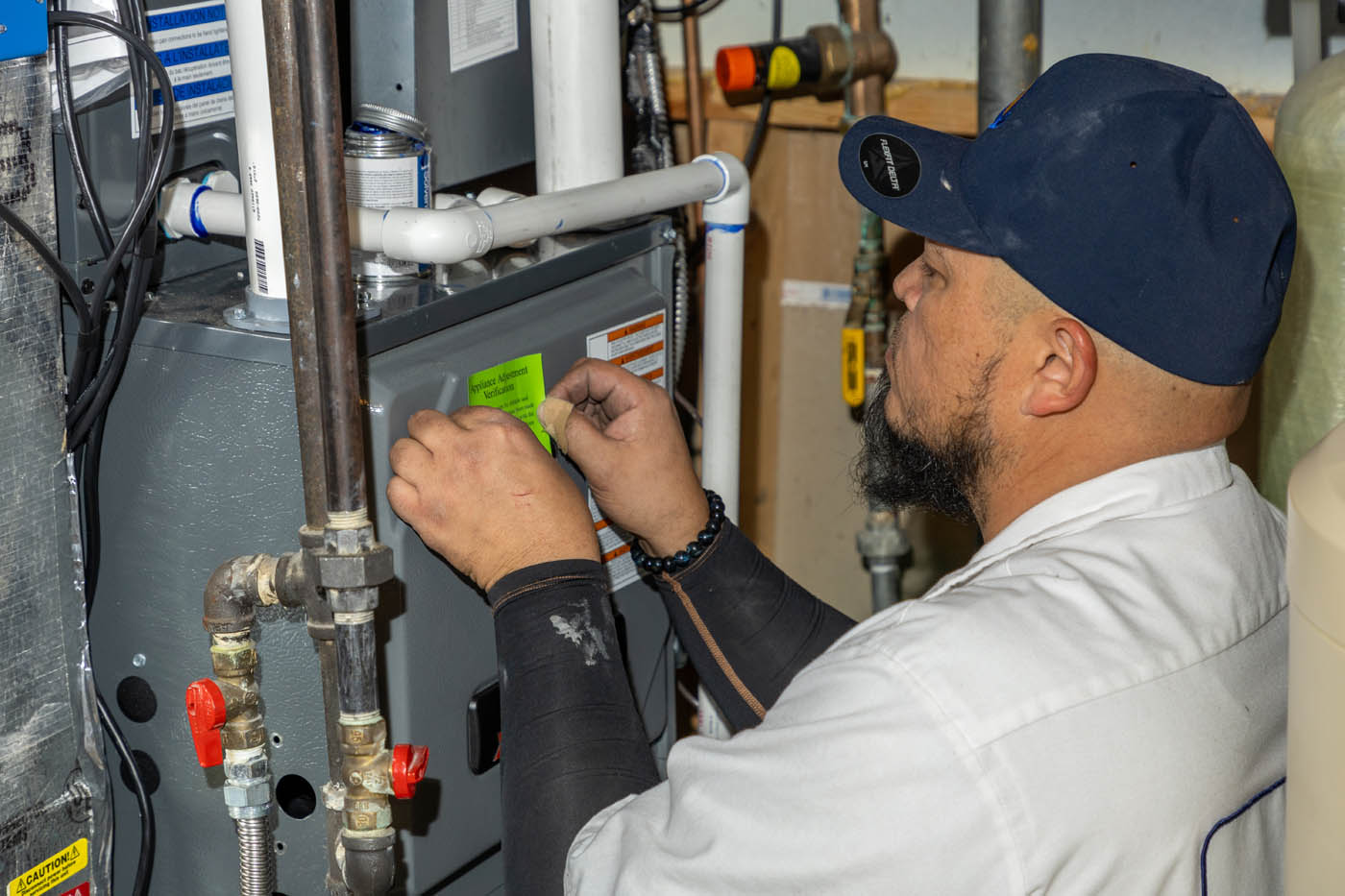 
		A Absolute Comfort employee working - we offer the best furnace maintenance services.
	