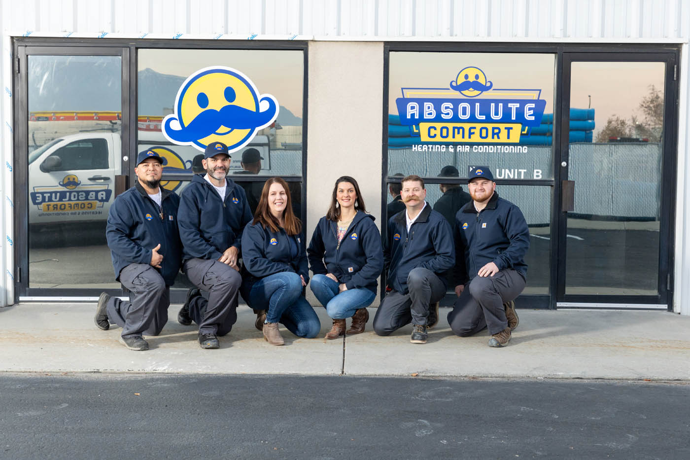 The Absolute Comfort Heating and Air Conditioning team together in front of our store.