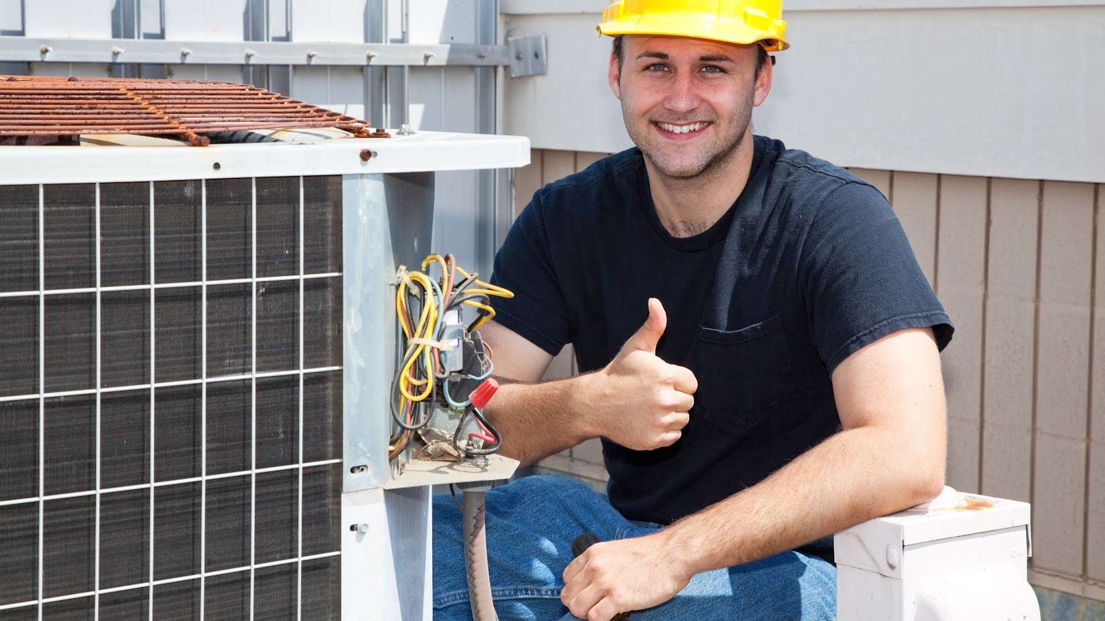 Air Condioner Repairman Thumbs Up A technician for Absolute Comfort kneels beside an AC unit, giving a thumbs-up sign in Ogden, UT