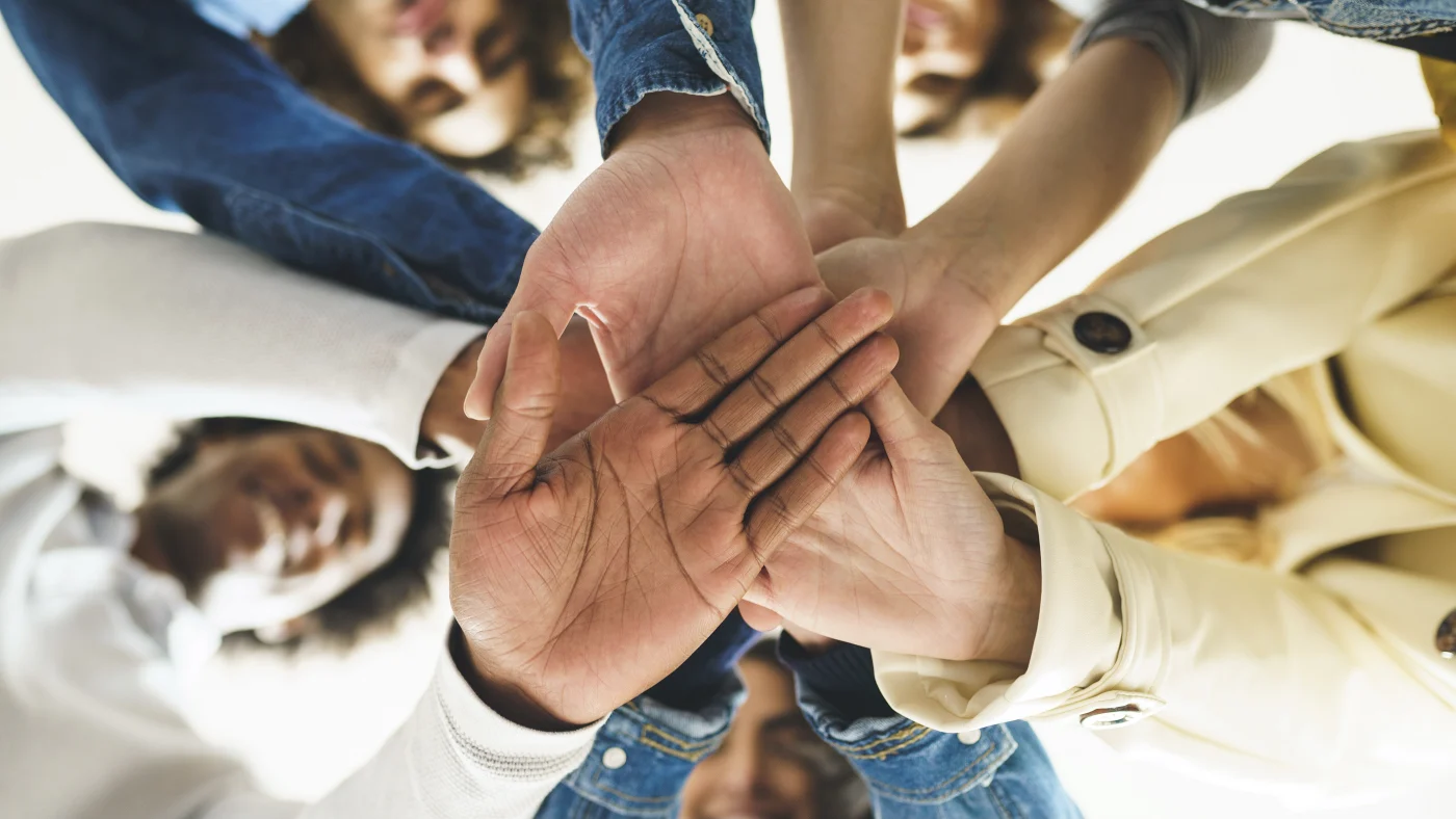 Close-up of multiple hands together in Ogden, UT community