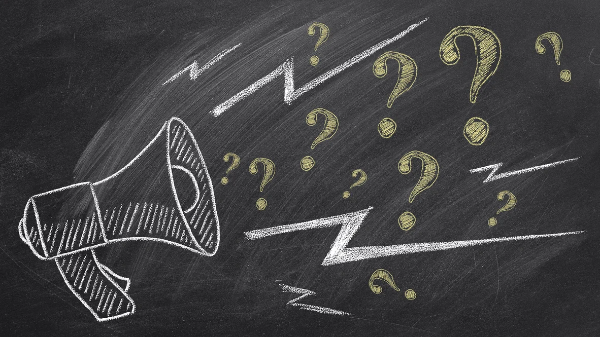 Chalkboard with megaphone and question marks drawn on