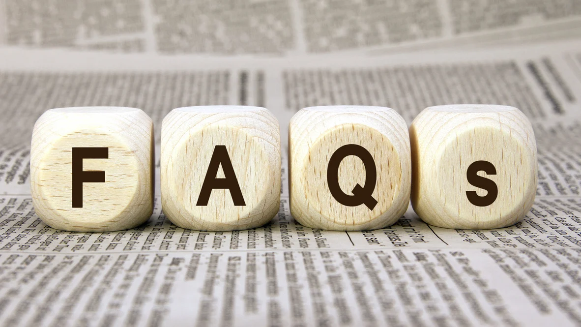 Dice with F, A, Q, s, on them on newsprint background