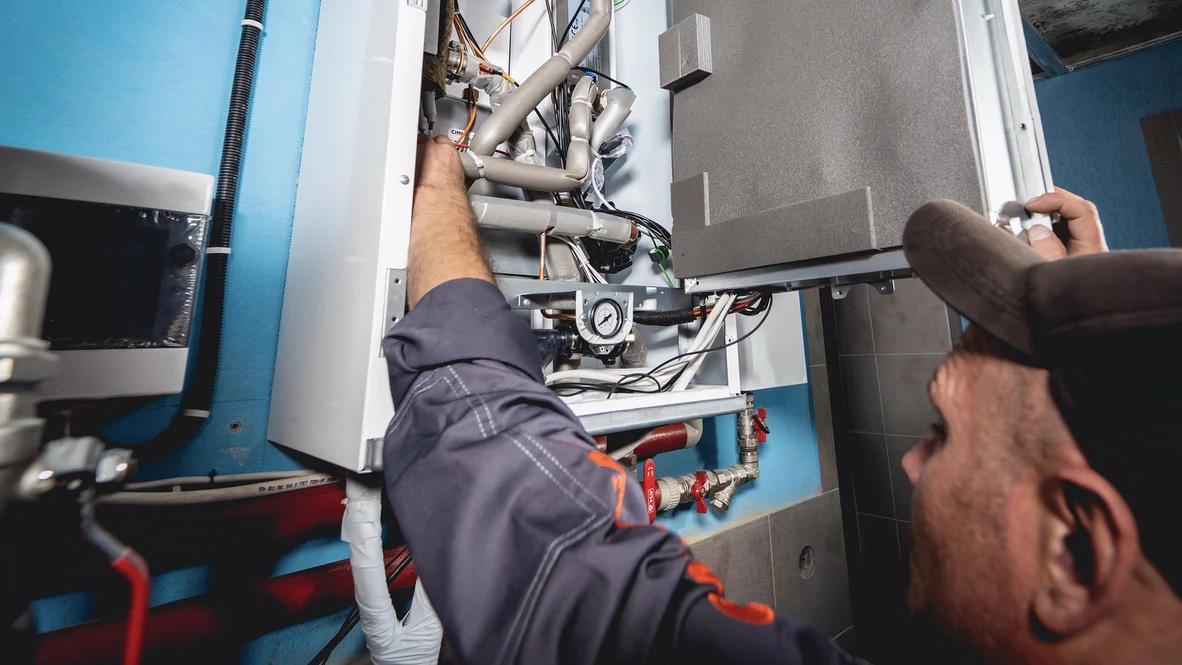 Absolute Comfort HVAC technician works on Ogden AC repair