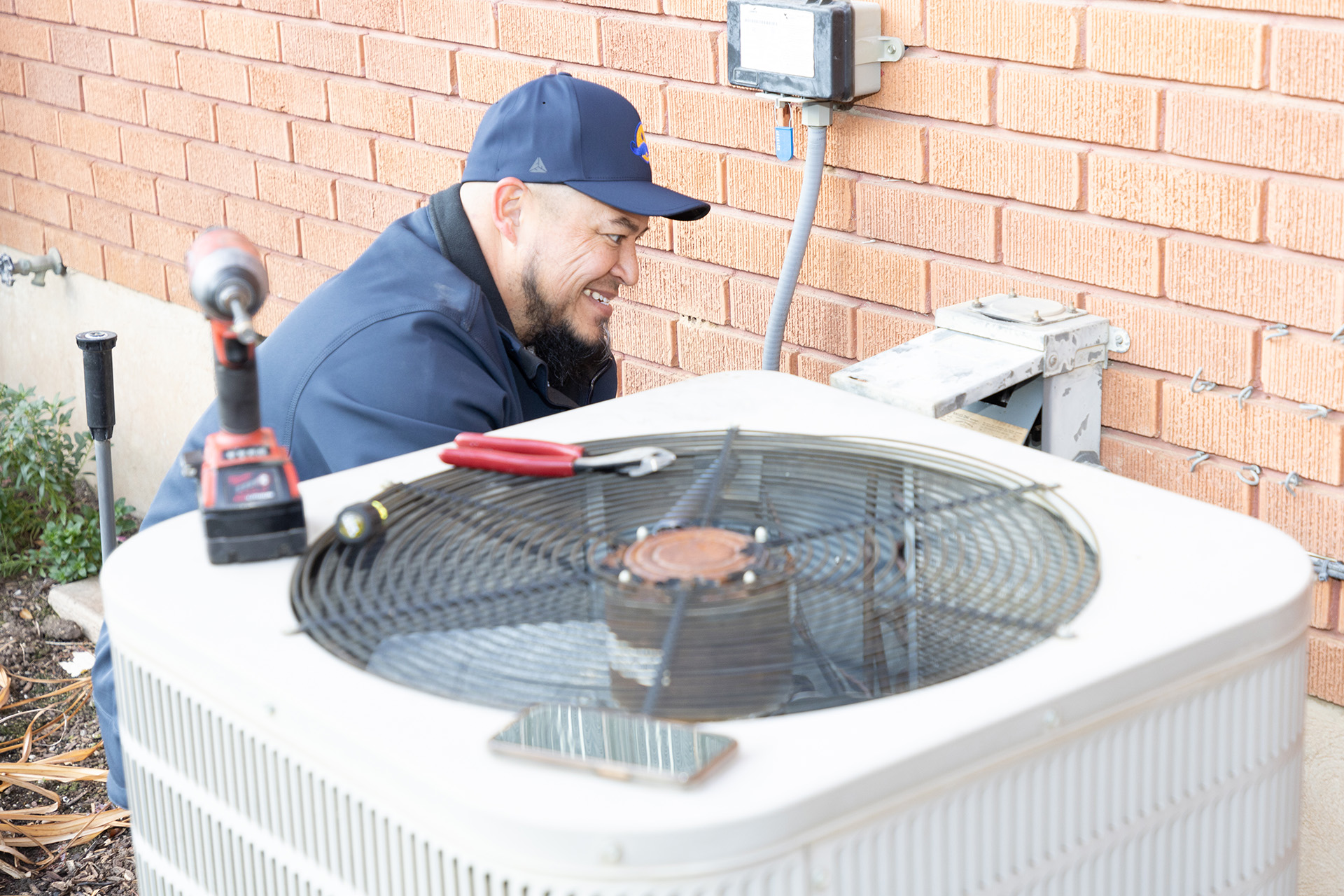 Repair HVAC – Ogden, Utah – Absolute Comfort Absolute Comfort technician repairs Ogden AC Condenser